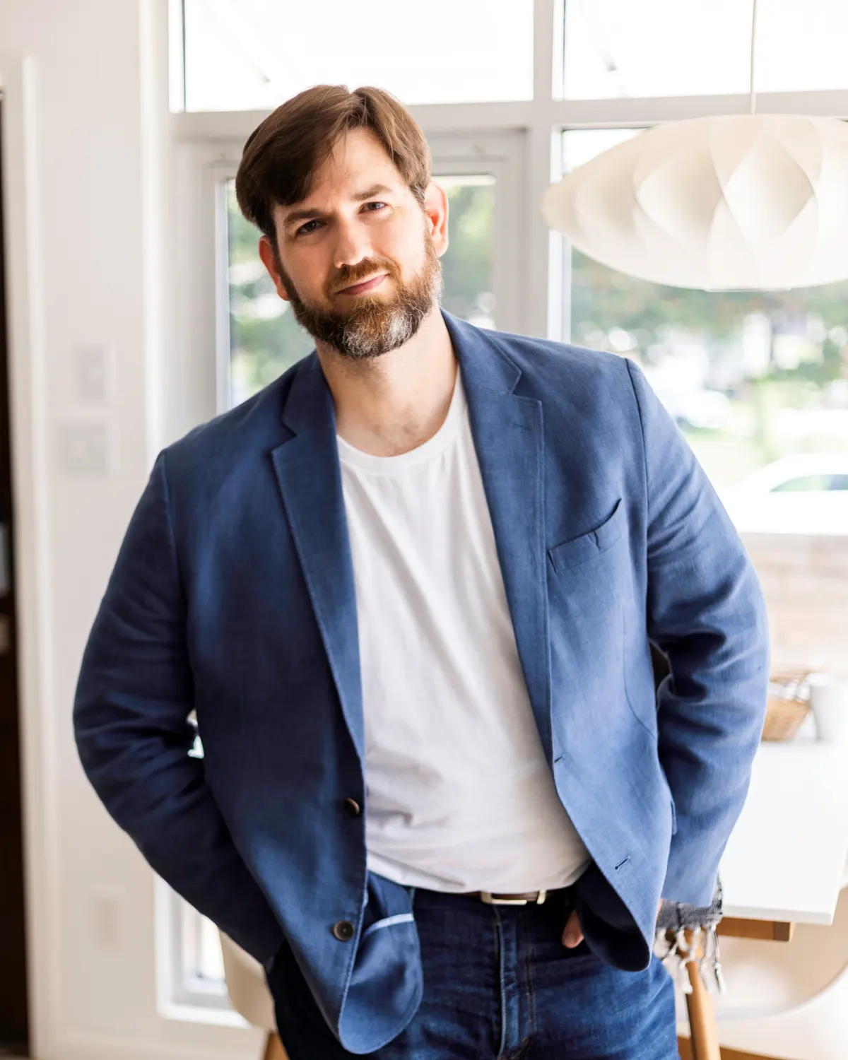 Paul Thompson, owner of Arkansas Lead Gen, standing in a bright open workspace in Little Rock
